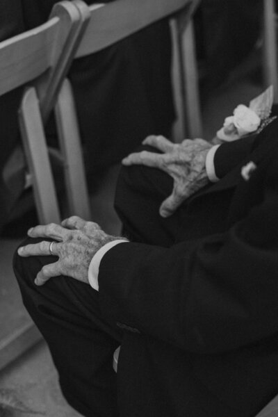 an old man's hands at a wedding ceremony in black and white
