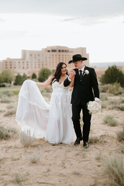bride and groom walking holding hands