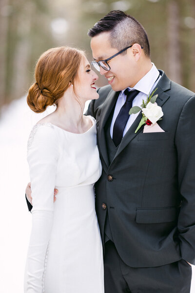 Capture the happiness of a bride and groom holding each other close after their winter wedding at Silvertip Resort in Canmore. A beautiful moment of love and joy amidst the stunning backdrop of the Canadian Rockies.