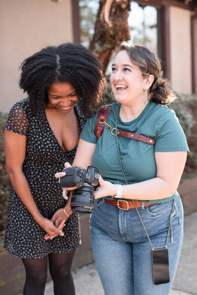 Laura and her client grin happily at a photoshoot