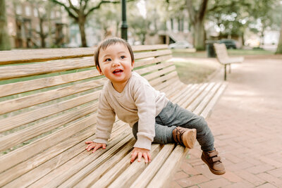 toddler sitting on bench in Chatham Square