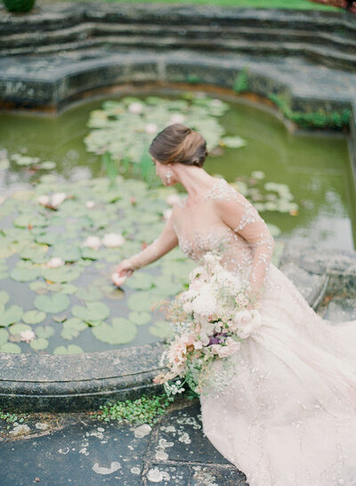 Romantic bridal portraits with a Lee Petra wedding dress alongside an English lily pond
