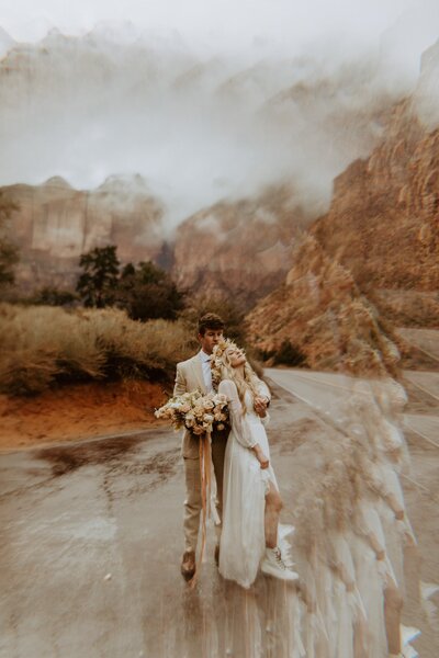 bride and groom posing on dirt road