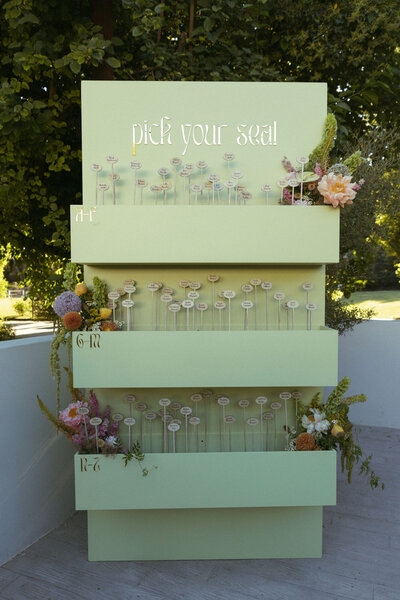 Olive green floral seating chart with custom names on a stick with flowers at Calamigos Ranch in Malibu California 