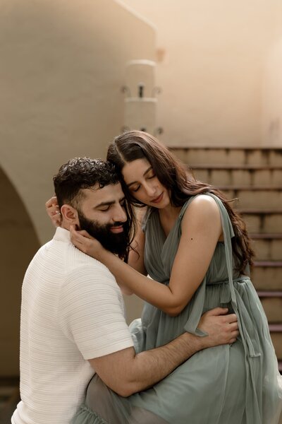 Pregnant woman and husband posing together