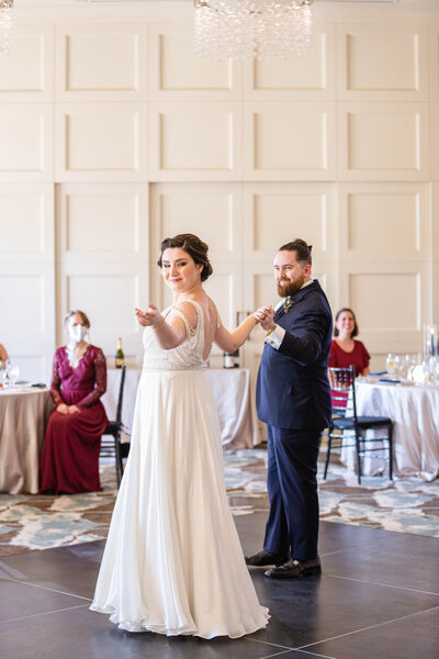 Bride and groom dance to their first song at their wedding reception.