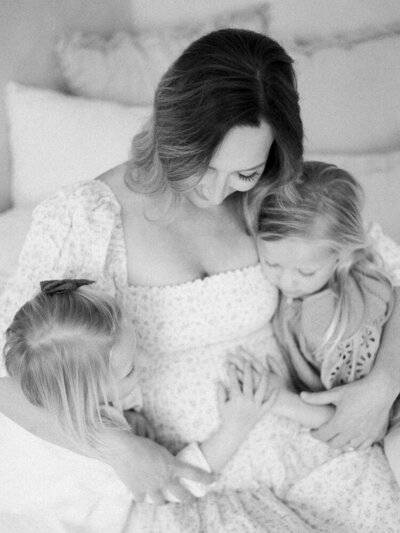 Mom and daughters, snuggling baby bump, photographed by Edmonton Maternity Photographer, Kahla Kristen