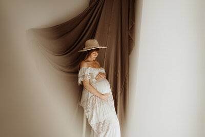Zwangere vrouw tijdens fotoshoot in bohemian studio