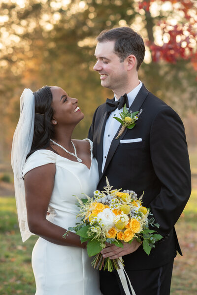 smiling couple under bridal veil
