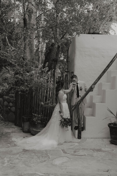 A romantic and elegant Mexico wedding moment, where the groom’s hand kiss symbolizes devotion and timeless love in a luxurious setting.