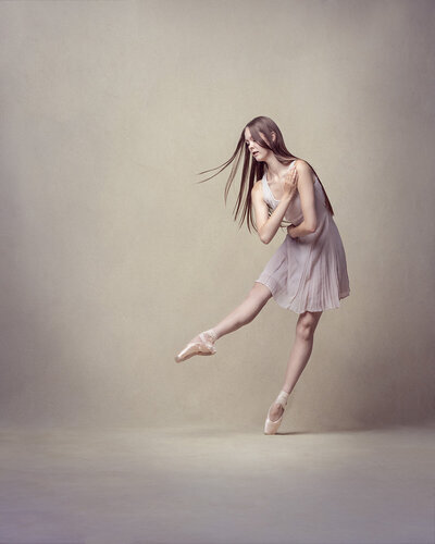 Young ballet dancer on a cream canvas mid routine. Taken on location at Workshop Studios, Norwich by Claire Howes.