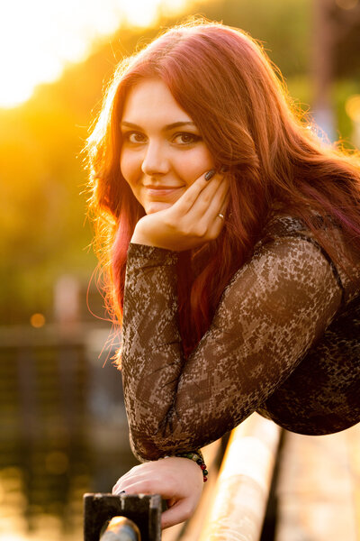 Senior girl smiles during sunset in Minneapolis, Minnesota.