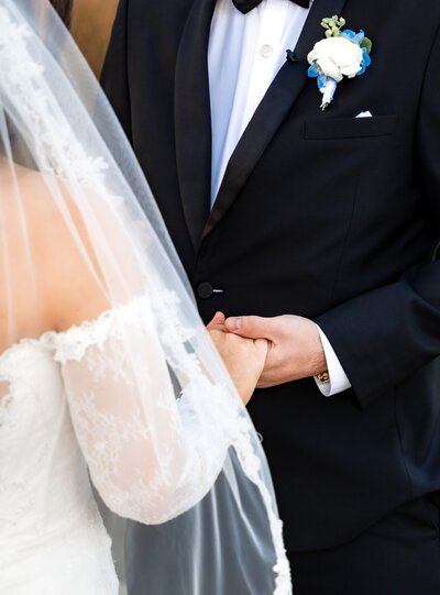 bride and groom holding hands