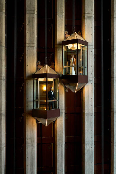 a high end portrait of a woman with high fashion clothes on , wearing red lipstick holding her face