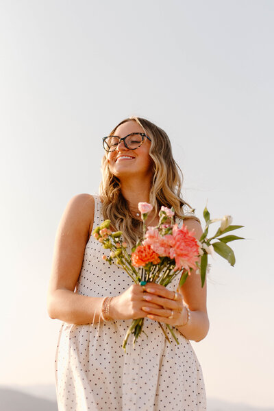 Arizona Senior holding Flowers in a wheat field during golden hour