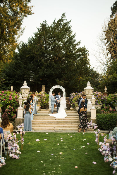 Bride giggling behind a tower of champagne