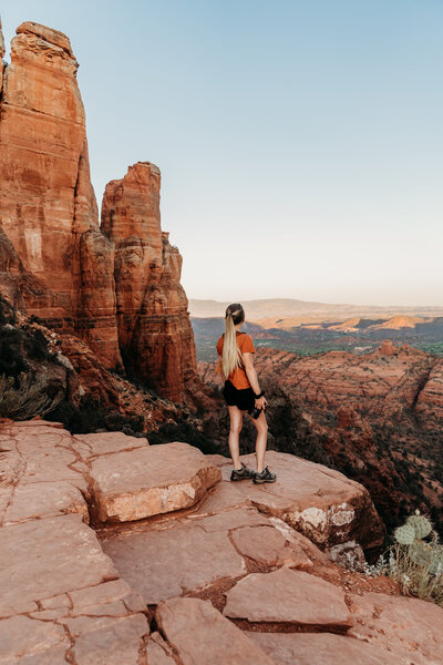 woman standing on red rocks