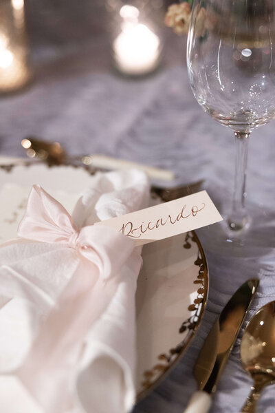 Gold flatware and calligraphy escort cards