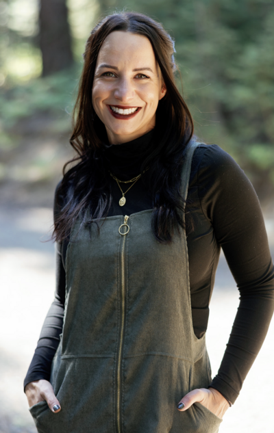 A lady sitting with her hands in her hair