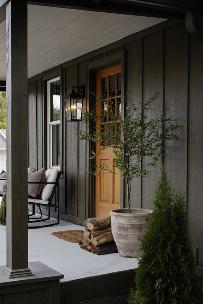 Front porch with green siding paint color. Muddled Basil by Sherwin Williams. Nadine Stay
