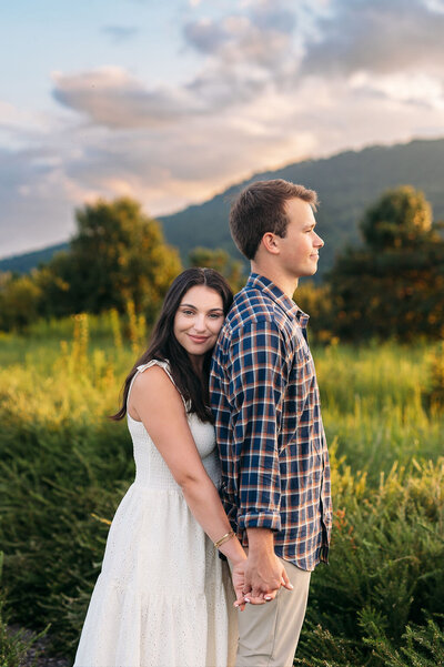 couple posed at sunset in open field with lookout mountain ga in background
