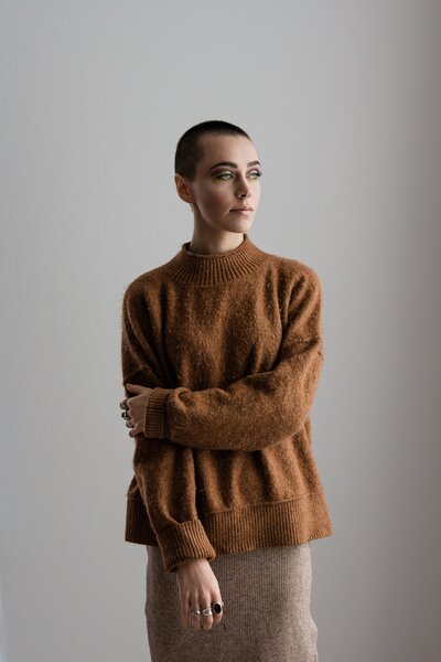 studio photograph of girl in brown sweater