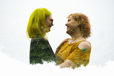 Silhouette of two men kissing with the blue sky and ocean behind them at their Micro Wedding