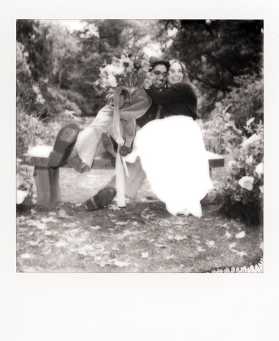 Polaroid-style film photo of a newlywed couple sharing a quiet moment in an arched doorway — captured by a film wedding photographer