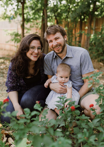 Mother and father looking at baby in crib at Austin family photo session