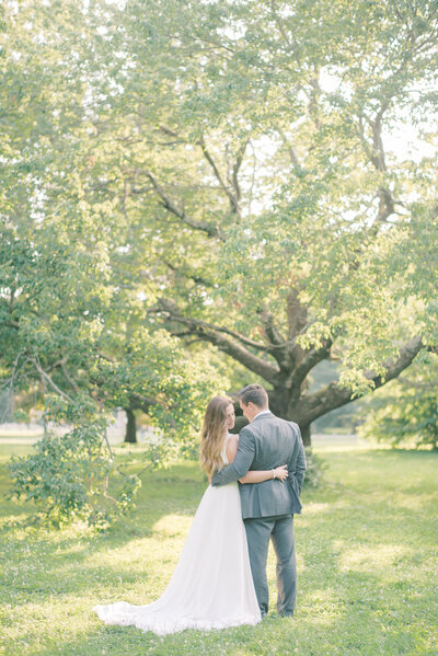 bride and groom relax together in a forest