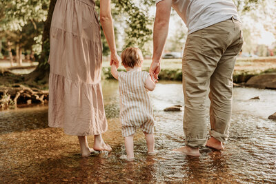 Golden hour family photos in Indianapolis, mom, dad and toddler holding hands