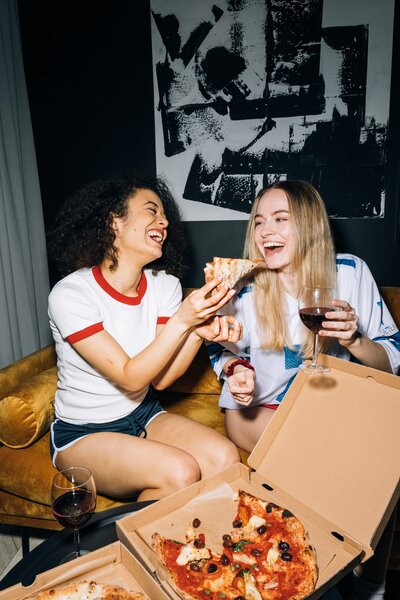 Photo Of Two Young Women ENjoying Wine & Pizz - Photo by KoolShooters