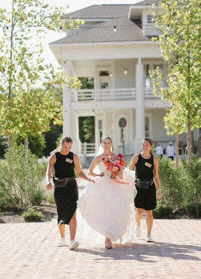 Austin wedding planners Bianca Nichole and Co holding bride's dress at The Grand Lady Austin