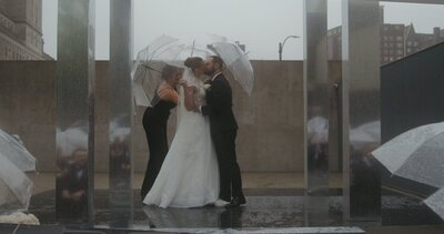 newlyweds kiss at ceremony alter in rain