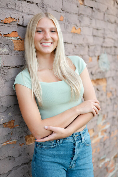 A close-up portrait of a high school senior girl smiling.