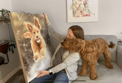 woman and dog looking at a picture of the dog