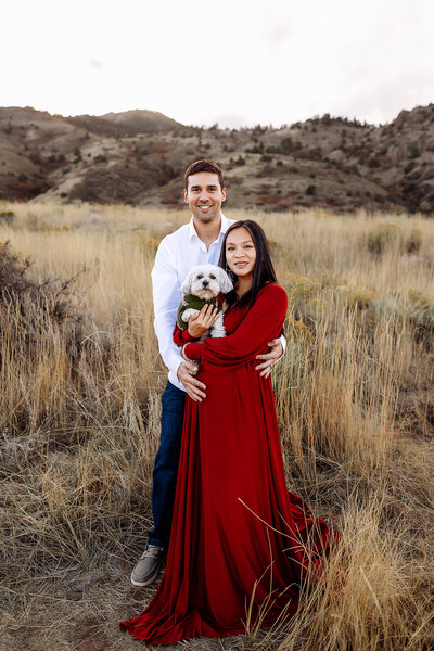 couples fall maternity photos at red rocks in morrison colorado stunning red maternity gown