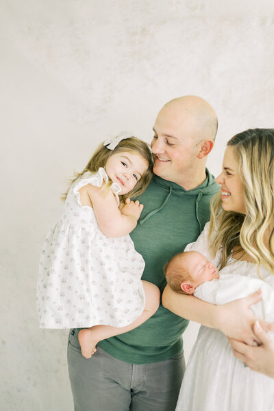 Franklin TN family smiling with toddler girl and newborn baby