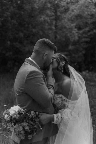 a couple kissing on their wedding day in glacier national park