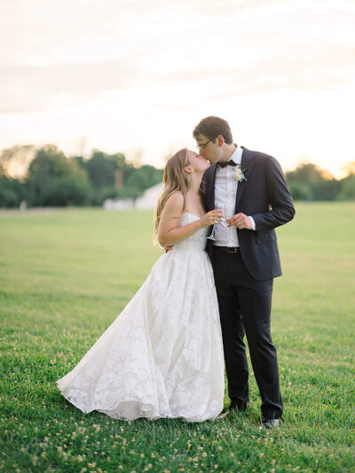 Bride and Groom kissing in the foothills of the Blue Ridge Mountains. Captured by Charlottesville Wedding Photographer Bethany Aubre Photography.