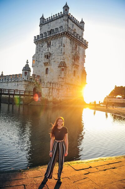 kacy beck in front of Belem Tower in portugal