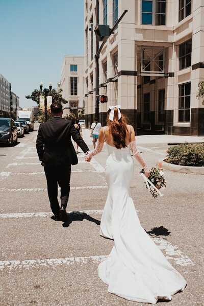 Bride and groom kissing at a rooftop bar overlooking the downtown Tampa skyline after their intimate wedding at Rooftop 220