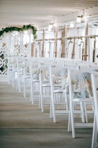 Chairs set up for wedding ceremony in a barn