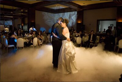 Man and woman dancing on clouds created with a fog machine