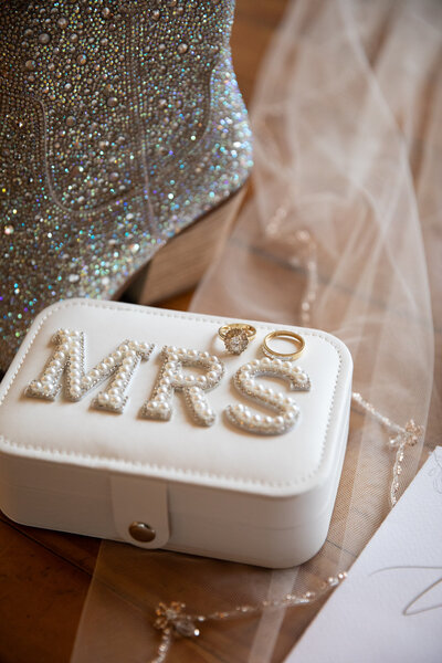 An Austin-based wedding photographer captures a white box with the word mrs next to a pair of shoes.