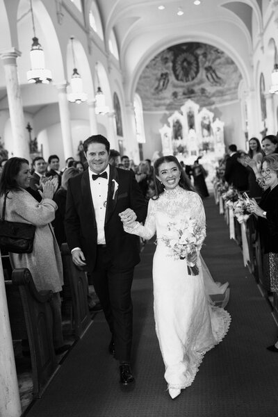 Close up view of delicate wedding dress skirt, wedding bouquet, and heels