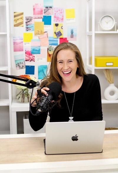 Krystal Proffitt podcast coach talking into podcast mic