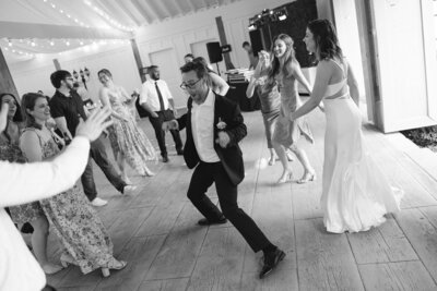 Black and white image of guests dancing at Nashville wedding reception