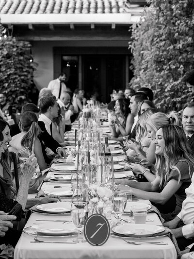 Guests seated at a sophisticated outdoor wedding reception during a destination celebration in Palm Springs, captured in a refined, documentary style by Elizabeth Kane Photography—serving Philadelphia, New York, and the East Coast with timeless, artful imagery.
