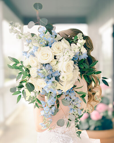 Bride holds a beautiful  bouquet  on her destination wedding.